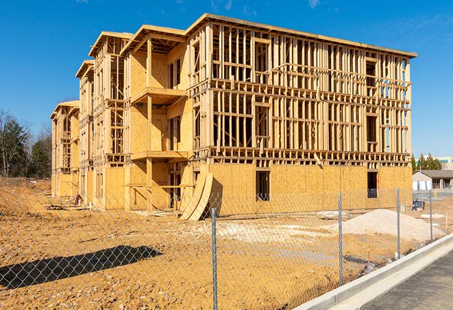 a close-up of temporary chain link fences enclosing a construction site, signaling progress in the project's development in Sunrise